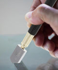 Glass Cutter Kit With Pencil Style Handle For Stained Glass Projects Includes Pro Grade Spare Blades And Tension Control Portable Do It Yourself Glass Bottle Craft Tool For Precise, Smooth Cuts. Hand holding glass cutter scoring a sheet