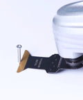 EZARC titanium oscillating tool blade with serrated gold edge for metal/wood cutting, close-up.