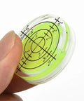 Close-up of Two Pack Mini Bubble Level Set With 20 To 30 Degree Accuracy for precise spirit level readouts in hand.