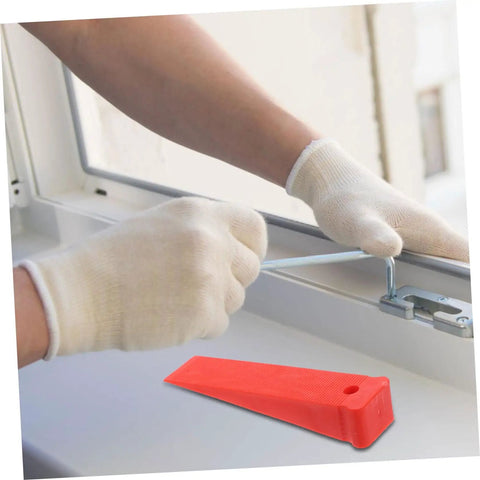 Red Plastic Leveling Wedges And Reusable Gap Filler Shims For Bullseye Door And Window Alignment used under a window for alignment.