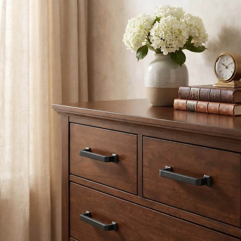 Slick Matte Black Cabinet Pulls And Drawer Handles 10 Pack on wooden dresser with vase and books, elegant decor.
