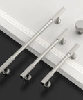 Top Shelf Brushed Satin Nickel Kitchen Cabinet Knobs 6 Pack Slick Drawer Handles, three sizes and round knob on white surface.