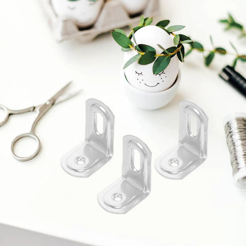 10 Pack Iron L Brackets With 90 Degree Rounded Corners for Shelves on white desk with crafting tools and decorative egg