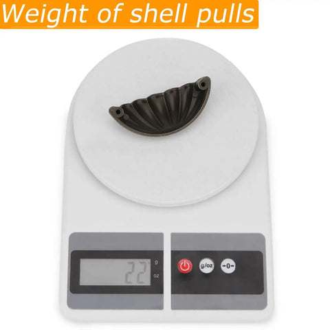Four Pack Bronze Semicircle Cabinet Pulls Featuring Heavy Duty Zinc Alloy Build And Hella Tough Grip For Kitchen Drawers on weighing scale.