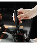 Professional Espresso Coffee Ground Distributor With 16 Stainless Steel Needles Magnetic Telescopic Stirrer Leveler used on coffee grounds.