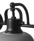 Close-up of a light fixture from Gladstone 5 Piece All In One Bathroom Set With Matte Black Finish Includes A 3 Light Vanity Fixture