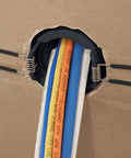 Construct Pro spring-lock cable pass-through port, 2 in ID, black, installed in drywall with cables
