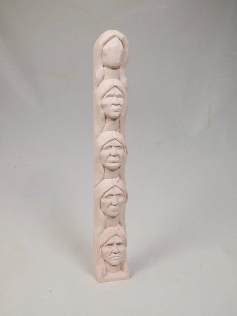 Learn To Carve A Native American Chief Face With A 12 Inch Hand Cast Resin Study Stick Kit showing carved faces for woodcarving practice.