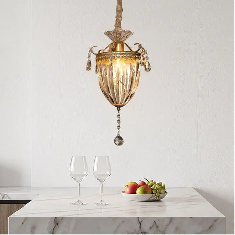 vhhob French Light Luxury Crystal Pendant Lamp Ceiling Hanging Fixture hanging above a marble table with glasses and fruit bowl.