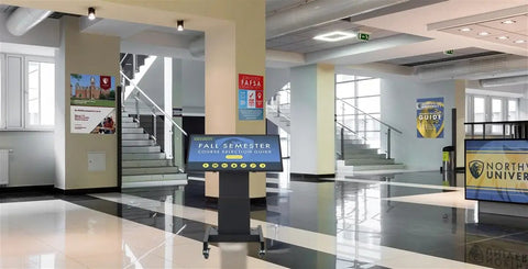 Built Tough 43 Inch Touchscreen Digital Signage Stand With Smooth Motorized Lift And Tilt Crisp Full HD 1080P Workhorse Mobile Kiosk For Retail Professionals in a school lobby.