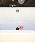 Mermaid Bathtub Stopper Rubber Plug with Chain for Easy Drain in a modern white bathtub, featuring a pink mermaid design.