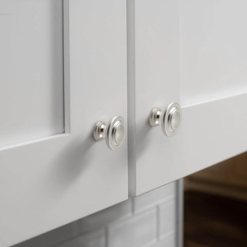 Close-up of bi-fold door with replacement diecast satin nickel plated knobs, wide base for hollow doors, 1-11/16 inch diameter, easy install
