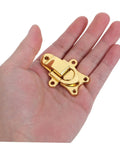 Super Cool 2 Piece Golden Zinc Alloy Duckbilled Toggle Latch Sets For Secure Wooden Cases, Tool Boxes, And Jewelry Storage With Heavy Duty Metal Clasp Locks To Keep Everything Locked Tight During Transit No Matter Where You Go, shown in a hand.