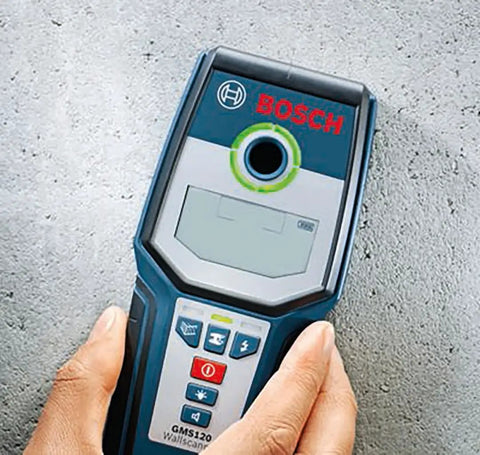 Person holding Wall Scanner For Studs Metal And Live Wiring With Center Finder Multi Mode Detection Green Orange Red Status Ring