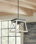 Briarwood Collection One Light Coastal Mini Pendant With Faux Wood Look Enclosure In Graphite Black Finish, shown in a modern room.
