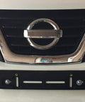 Front License Plate Mounting Kit With Tag Holder Adapter For Nissan All Models Flat Bumper Design Left Or Right Mount Includes Six Screws And Two Built In Nuts Plug And Play Premium Car Set Accessories Easy Install shown installed on Nissan grill