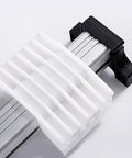 Electric linear actuator slide block; close-up view of white ribbed plastic on silver aluminum rail with black end cap