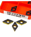 DCMT carbide inserts in orange storage box, ideal for steel cutting with 10 Pc Indexable Carbide Lathe Tools for Hard Alloy Turning.