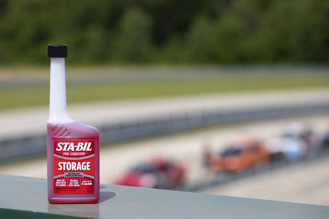 Storage fuel stabilizer bottle on ledge; product for long-term fuel freshness and engine protection, 10 oz for 25 gallons.
