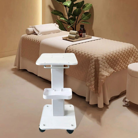 Premium Iron Wood Aluminum Salon Trolley With Smooth Rubber Wheels Built Tough Rolling Beauty Station Cart For Hair Stylist Tool Storage And Salon Floor Organization Game Changer in a spa setting with a cream quilted bed.