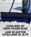 Person using 36 Inch Extra Large Ergonomic Snow Pusher with Steel Handle for easy driveway clearance on snow-covered surface