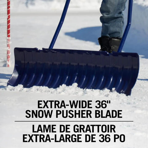 Person using 36 Inch Extra Large Ergonomic Snow Pusher with Steel Handle for easy driveway clearance on snow-covered surface
