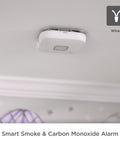 Slick Hardwire Smart Smoke And Carbon Monoxide Detector With Instant Phone Alerts mounted on ceiling, white design, wired model.