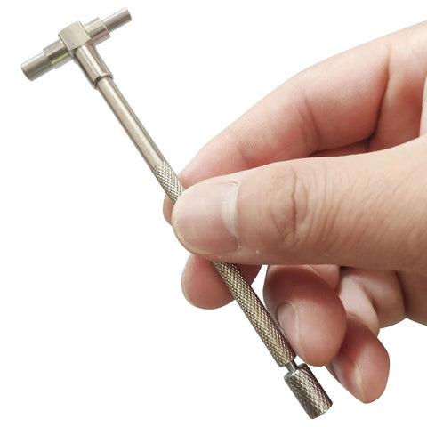 JENSWILL telescoping bore gauge, 6‑pc set, close-up of knurled stainless rod with T-bore head held by fingers