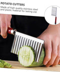 Front view of SHOWERORO 2-piece wavy stainless steel potato cutters with red ergonomic handles slicing a cucumber.