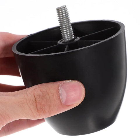 Hand holding durable black plastic furniture leg with screw, part of durable black plastic furniture legs for chairs and sofas easy screw on replacement feet with adjustable height protective sturdy and safe for home use.