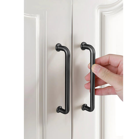 Hand holding 5 Pack 5 Inch Matte Black Kitchen Cabinet Handles And Modern Cabinet Pulls For Cabinets Cupboards Dressers And Drawer Pulls