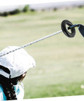 Woman practicing golf with Two Pack Weighted Golf Swing Trainer Rings For Beginners, Warm Up Practice Tool To Boost Your Swing Power And Stability