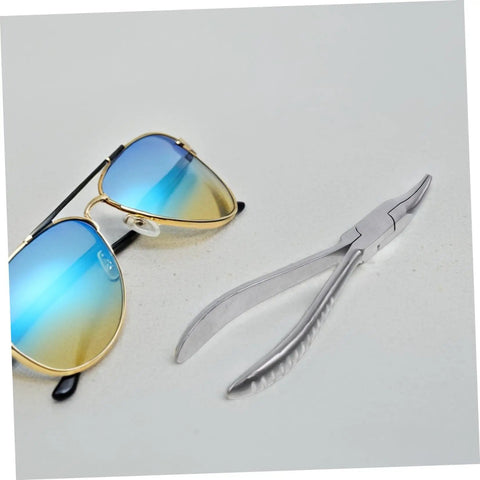 Stainless Steel Eyeglasses Repair Tool With Angled Pliers next to sunglasses for adjusting frames quick and easy eyewear fixes.