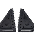 Two solid rubber wheel chocks with traction ribs and handy handle, 8x4x6 in size, designed for securing vehicles on slopes.