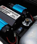 Close-up of Heavy Duty Road Trip Ready 12 Volt Twin Motor Portable Air Compressor's dual motors and pressure settings.