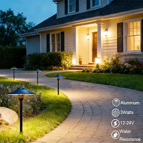 Cast Aluminum Low Voltage Landscape Pathway Lights with Ground Spike And Wire Connectors, Replaceable 3W G4 LED Bulbs In Warm White, illuminating a walkway in a garden setting.