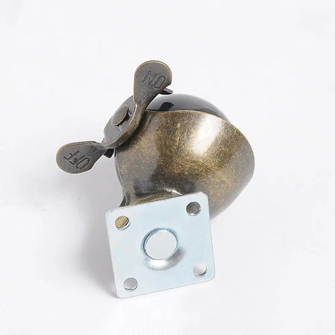 Top Shelf 4 Pack Heavy Duty Furniture Caster Wheels In Antique Brass With 360 Degree Swivel Tops - close-up view of one wheel with brake.