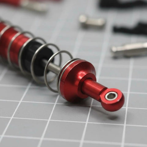 Sick Steel Steering Upgrade Linkage Set For Wltoys 12429 RC Car With Premium Shock Absorber Hardware Damping System close-up of red shock absorber