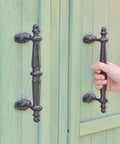 Two Pack Rustic Cast Iron Cabinet Handles Heavy Duty 9.3 Inch Long Door Pulls For Cabinets Doors Gates Closets Drawers With Antique Farmhouse Charm Built To Last And Easy To Install, installed on a green cabinet