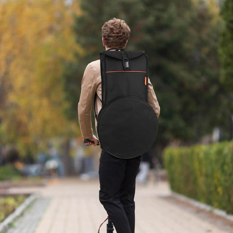 Heavy Duty 12 Inch Practice Pad Backpack That Stays Totes Waterproof And Shields All Your Drum Gear securely on a person outdoors.