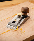 Bench Dog Small Chisel Plane Durable Flush Plane With Hardened Blade on wooden board shavings in workshop
