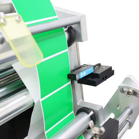 Close-up of Fully Automatic Desktop Top And Side Labeler Machine With Adjustable Speed Control Fits Bottle Sizes From 1.57 To 3.9 Inches.