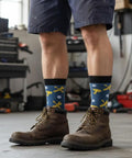 Mechanic Socks Gift Set For Men And Women worn by person in workshop, featuring tool patterns, ideal for auto enthusiasts.