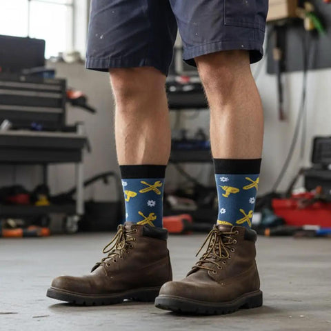 Mechanic Socks Gift Set For Men And Women worn by person in workshop, featuring tool patterns, ideal for auto enthusiasts.