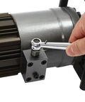 Close-up of a hand using a wrench on the motor of the 1150W Hydraulic Electric Rebar Bender for construction.