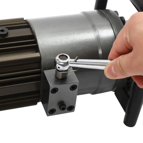 Close-up of a hand using a wrench on the motor of the 1150W Hydraulic Electric Rebar Bender for construction.