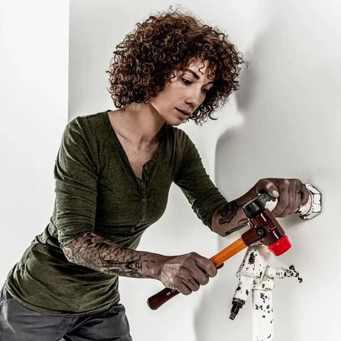 Person using Soft Face Mallet Workhorse With Dual Inserts Black Medium Hard Rubber Insert And Red Hard Plastic Insert Cast Iron Housing