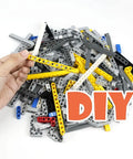 Hand holding yellow beam from 582 Piece Dope Tech Parts Set With Beams Axles Connectors Pins Panels For Building Blocks And Robot Kits
