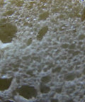 Close-up of Heavy Lifters Expanding Spray Foam Sealant Fills Gaps And Cracks Straight Up, showcasing its foam texture.