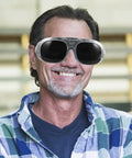 Shop Ready Welding Safety Goggles With Robust Impact And Splash Guarding Rock Solid Ergonomic Comfort on a person smiling.